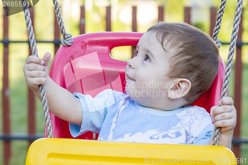 Image of baby boy in swing