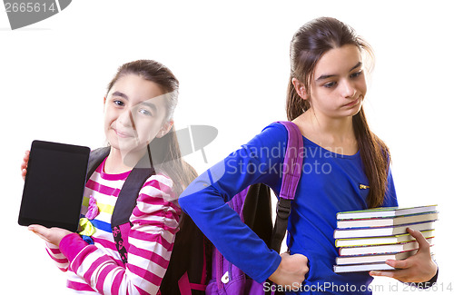 Image of Teenage Girls Using Digital Tablet and books