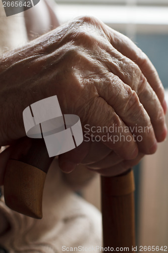 Image of Hand of a senior man with a  cane