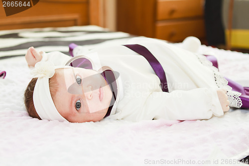 Image of Newborn baby girl looking at camera