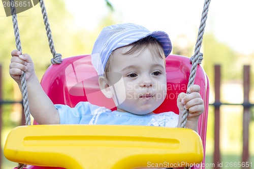 Image of baby boy swinging