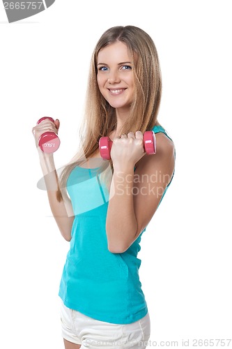 Image of Young teen girl with dumbbells