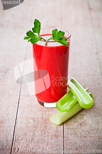 Image of tomato juice in glass and green celery