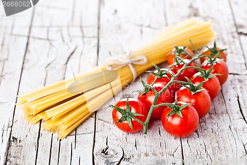 Image of uncooked pasta and fresh tomatoes