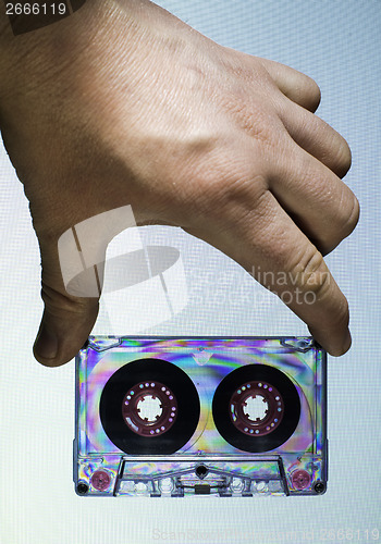 Image of Hand holding vintage cassette tape