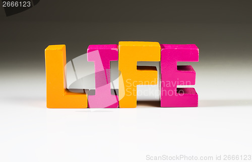 Image of Multicolored word life made of wood.