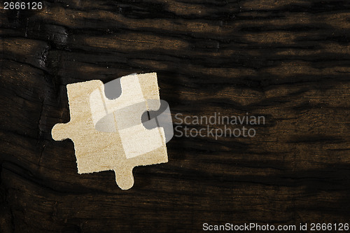 Image of Wooden puzzle on dark background. 