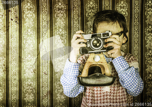 Image of Child taking pictures with vintage camera