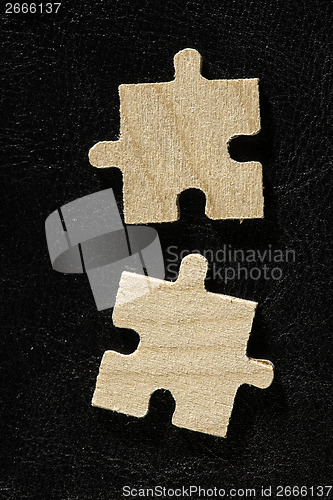Image of Wooden puzzle on black background