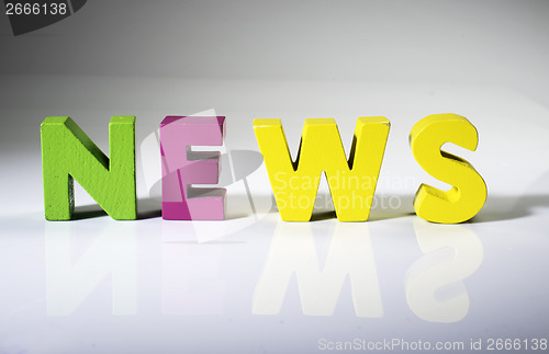 Image of Multicolored word news made of wood.