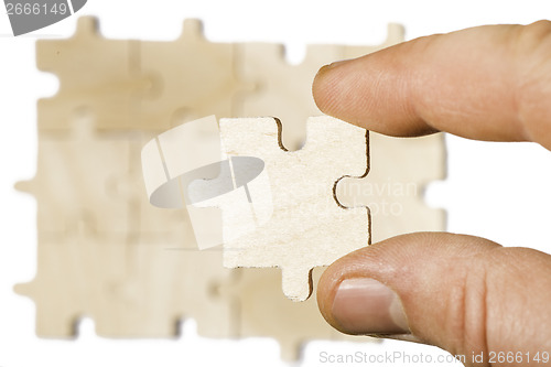 Image of Wooden puzzle on white background. . Close up