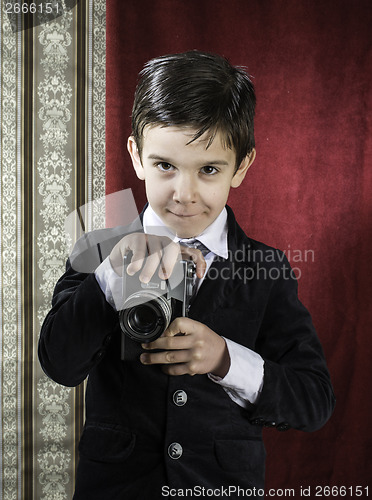 Image of Child taking pictures with vintage camera