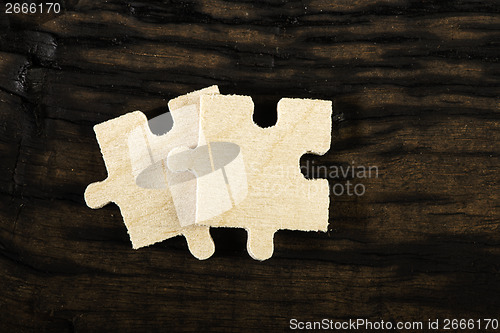 Image of Wooden puzzle on dark background. 