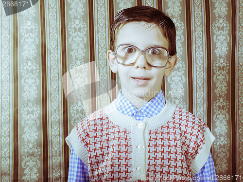 Image of Smiling child with glasses in vintage clothes