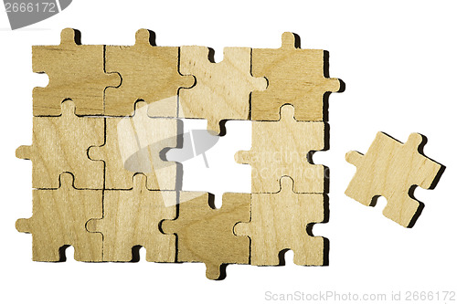 Image of Wooden puzzle on white background. 