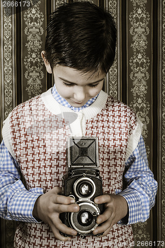 Image of Child taking pictures with vintage camera
