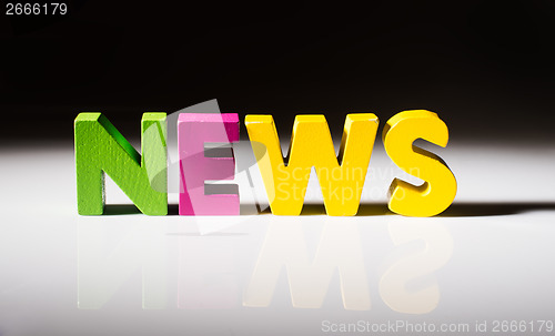 Image of Multicolored word news made of wood.