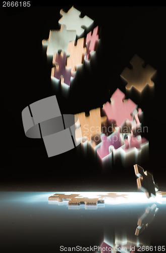 Image of Falling puzzle pieces.