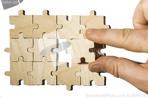 Image of Wooden puzzle on white background. . Close up