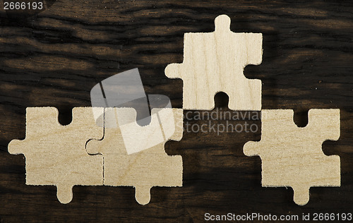 Image of Wooden puzzle on dark background. 