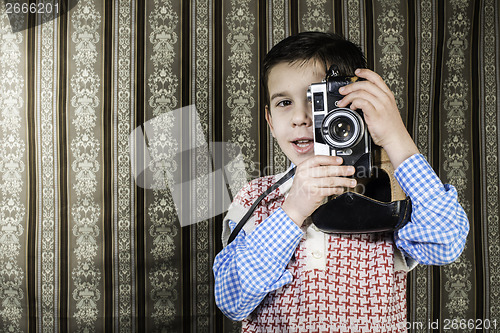 Image of Child taking pictures with vintage camera
