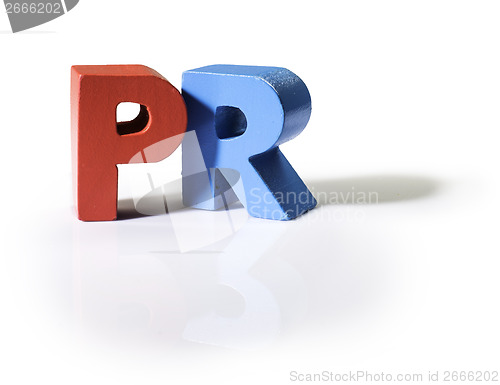 Image of Multicolored word PR made of wood.