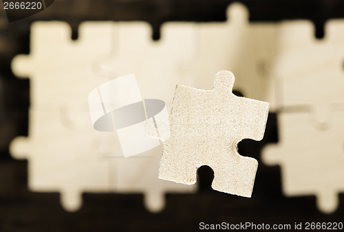 Image of Wooden puzzle on dark background. 