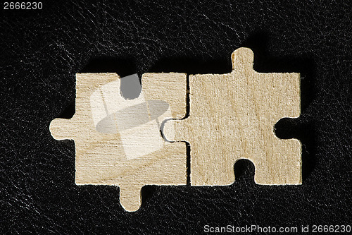 Image of Wooden puzzle on black background
