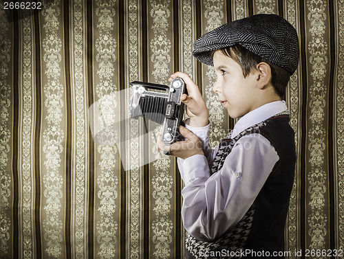 Image of Child taking pictures with vintage camera