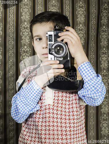 Image of Child taking pictures with vintage camera