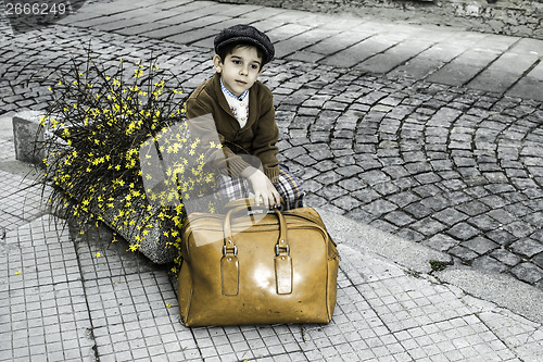 Image of Child on a road with vintage bag
