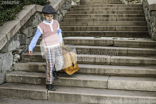 Image of Exterior stairs and child with vintage bag