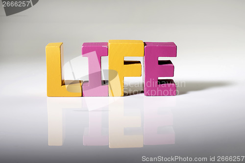 Image of Multicolored word life made of wood.