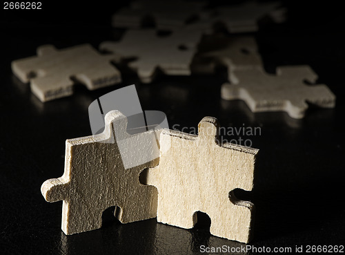 Image of Wooden puzzle on black background