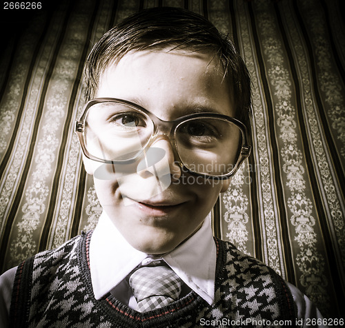 Image of Smiling child with glasses in vintage clothes