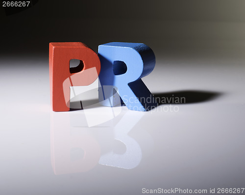 Image of Multicolored word PR made of wood.
