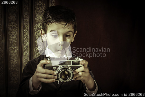 Image of Child taking pictures with vintage camera