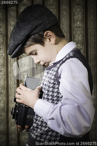 Image of Child taking pictures with vintage camera