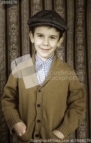 Image of Smiling child in vintage clothes and hat