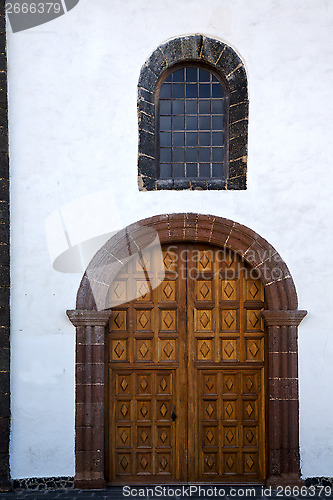 Image of lanzarote  spain canarias brass brown knocker  and white wall ab