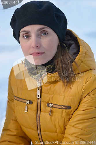 Image of Woman in black beret and yellow jacket