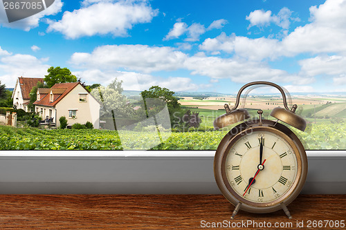 Image of View of house on summer vineyard landscape from window with alar