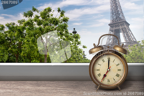 Image of View of Paris and Eiffel tower from window with alarm clock