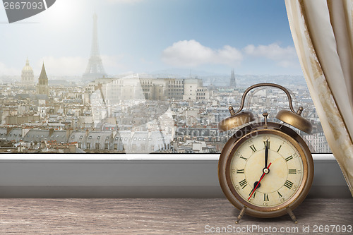 Image of View of Paris and Eiffel tower from window with alarm clock