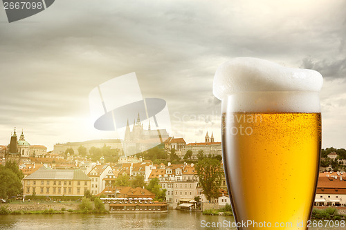 Image of Glass of beer against view of the St. Vitus Cathedral in Prague