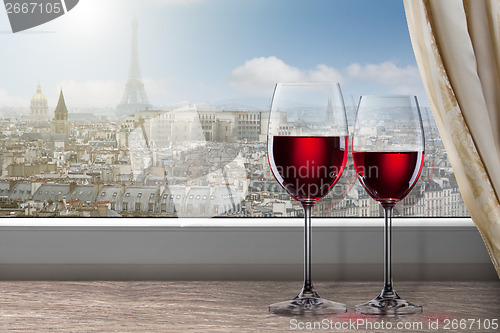 Image of View of Paris and Eiffel tower from window with two glasses of w
