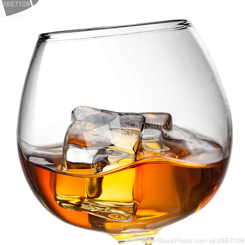 Image of Splash of whiskey with ice in glass isolated on white background