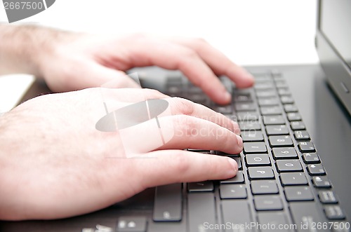 Image of Hand on laptop keyboard