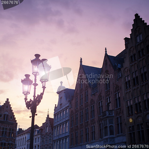 Image of Silhouettes of city center houses in Bruges against beautiful su
