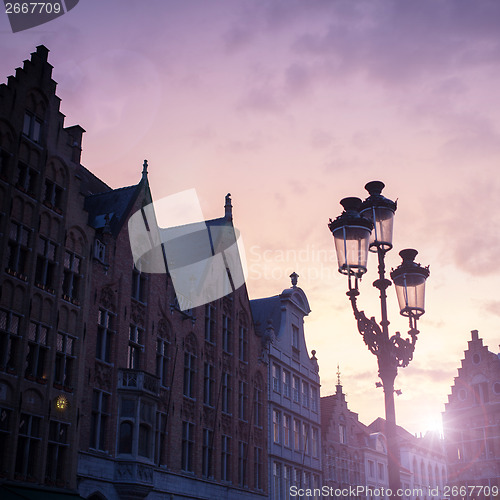 Image of Silhouettes of city center houses in Bruges against beautiful su